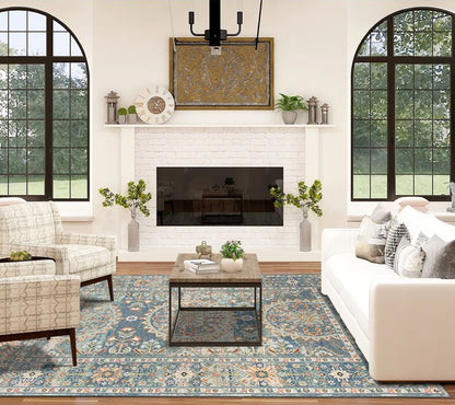 Living room with a fireplace, sofa, chairs, and decorative elements.