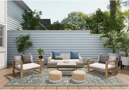 Outdoor patio set with furniture and decor on a wooden deck.