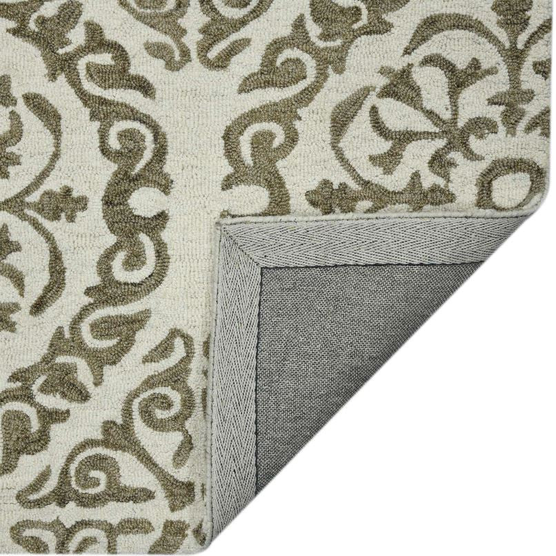 Corner of a patterned rug with decorative design on a white background