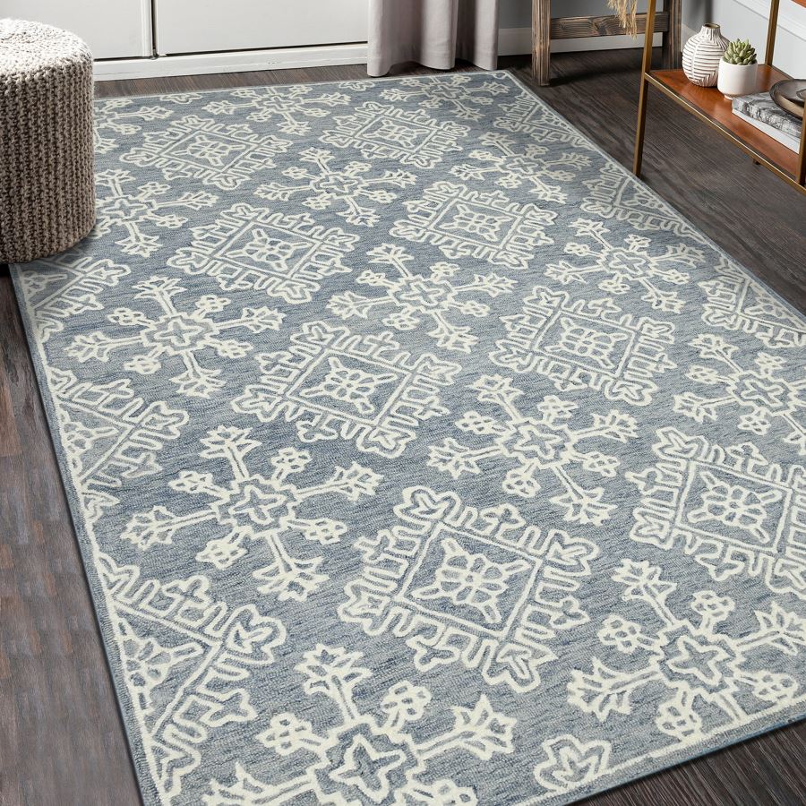 Patterned blue and white rug on a wooden floor