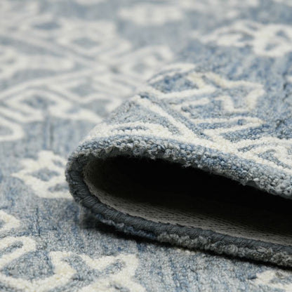 Close-up of a textured blue and gray area rug with geometric pattern