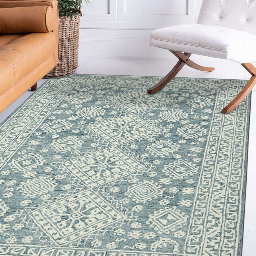 Patterned rug in a room with a brown sofa and white chair.