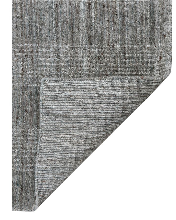 Gray textured rug corner on a white background