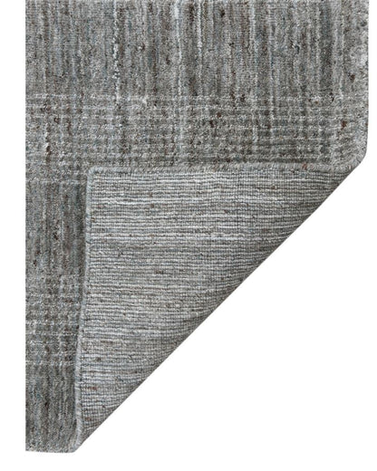 Gray textured rug corner on a white background