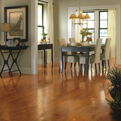 Dining room with wooden floor, table, chairs, and decor.