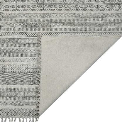 Gray and white patterned fabric with fringes on a white background