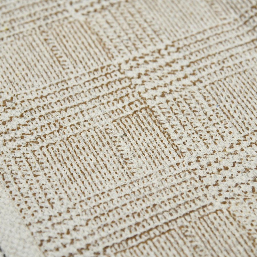 Close-up of a textured beige fabric with a diamond pattern