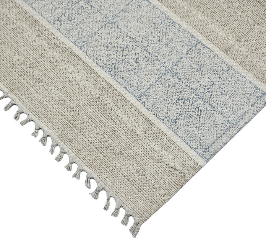 Textured rug with geometric pattern and tassels on a white background