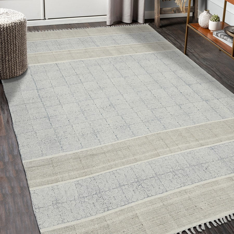 Gray and beige checkered area rug in a room with wooden flooring and furniture.