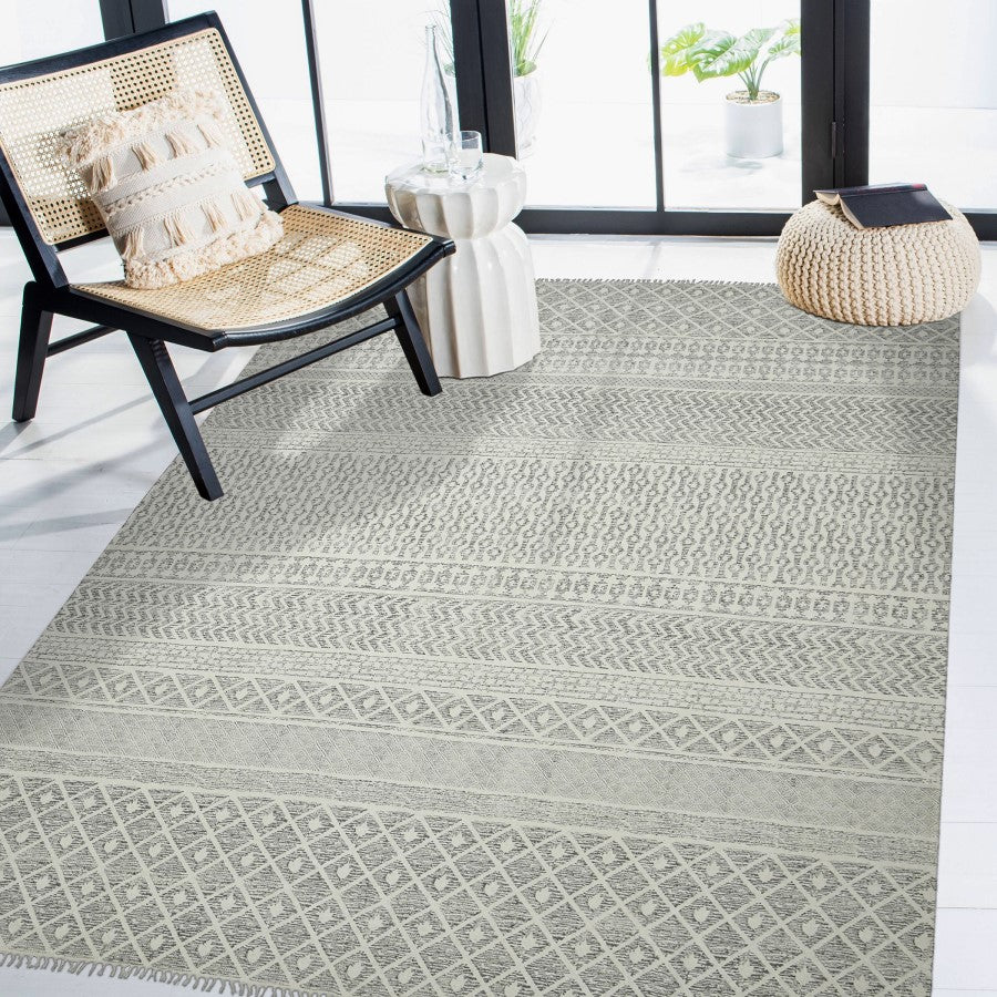 Patterned rug on a floor with a chair and decorative items in the background