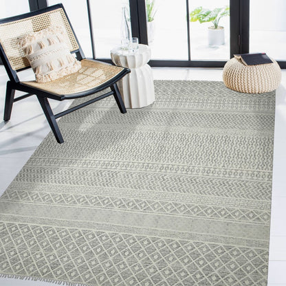 Patterned rug on a floor with a chair and decorative items in the background