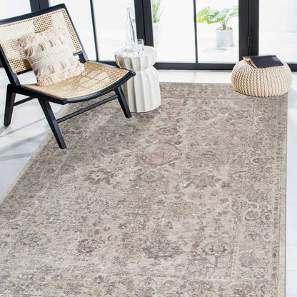 Gray patterned rug in a room with a chair and decorative items.
