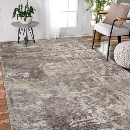 Living room with a patterned gray rug, chair, and small table.
