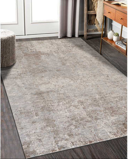 Gray area rug in a room with wooden flooring and furniture.