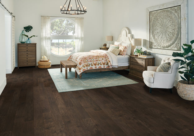 Modern bedroom with wooden flooring, bed, and decor