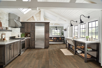 Modern kitchen with wooden cabinets, stainless steel appliances, and large windows.