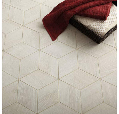 Hexagonal tiles on a floor with a red towel and brown rug.