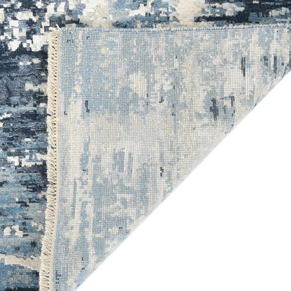 Blue and white textured area rug with a corner showing