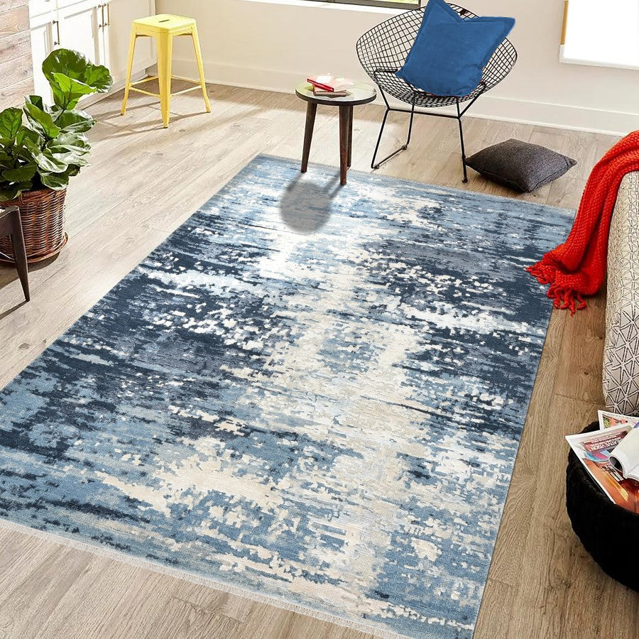 Blue abstract patterned rug in a living room setting with furniture and decor.