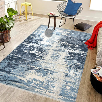 Blue abstract patterned rug in a living room setting with furniture and decor.