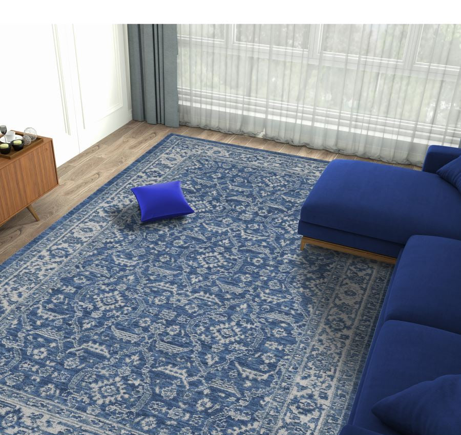 Living room with a blue patterned rug and matching sofa.