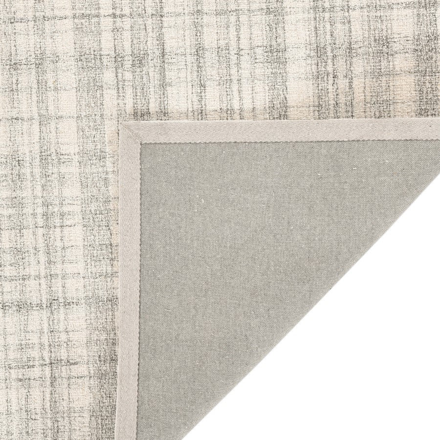 Textured rug corner with a neutral color palette on a white background