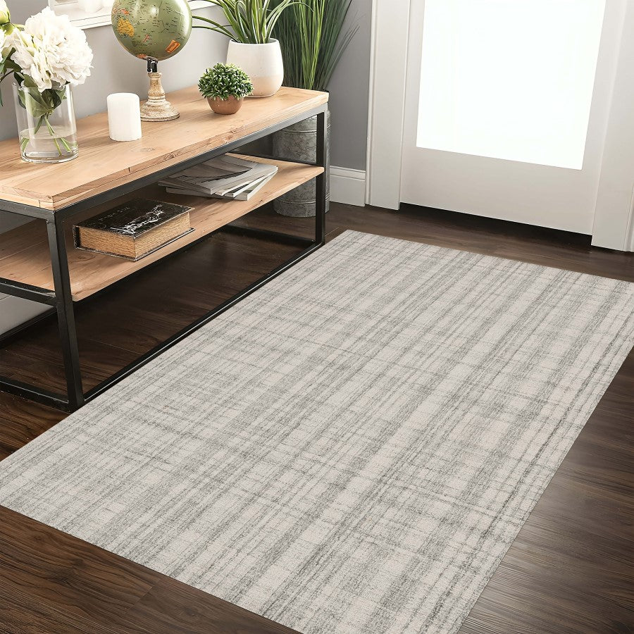 Long rectangular rug on a wooden floor with a shelf and decor items in the background.