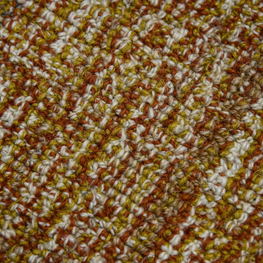 Close-up of a textured fabric with brown, white, and yellow pattern