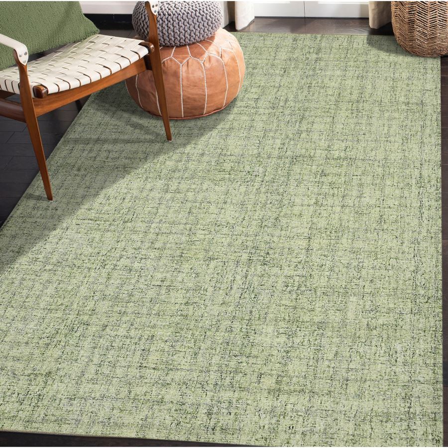 Green textured rug in a room with a chair and ottoman.