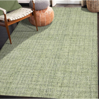 Green textured rug in a room with a chair and ottoman.