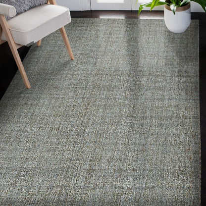 Gray textured carpet in a room with a chair and plant