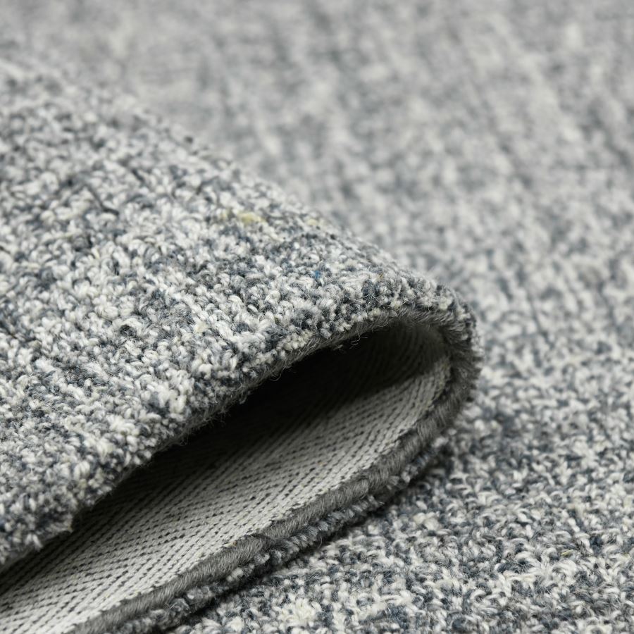 Close-up of gray textured carpet roll