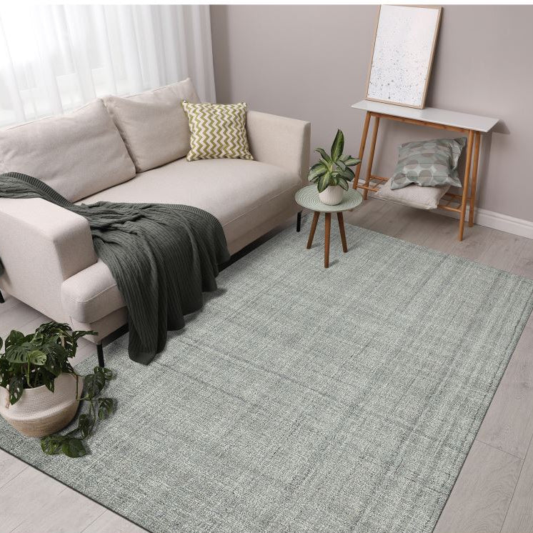 Living room with a gray rug, beige sofa, and decorative items.