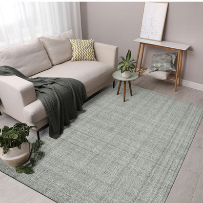 Living room with a gray rug, beige sofa, and decorative items.