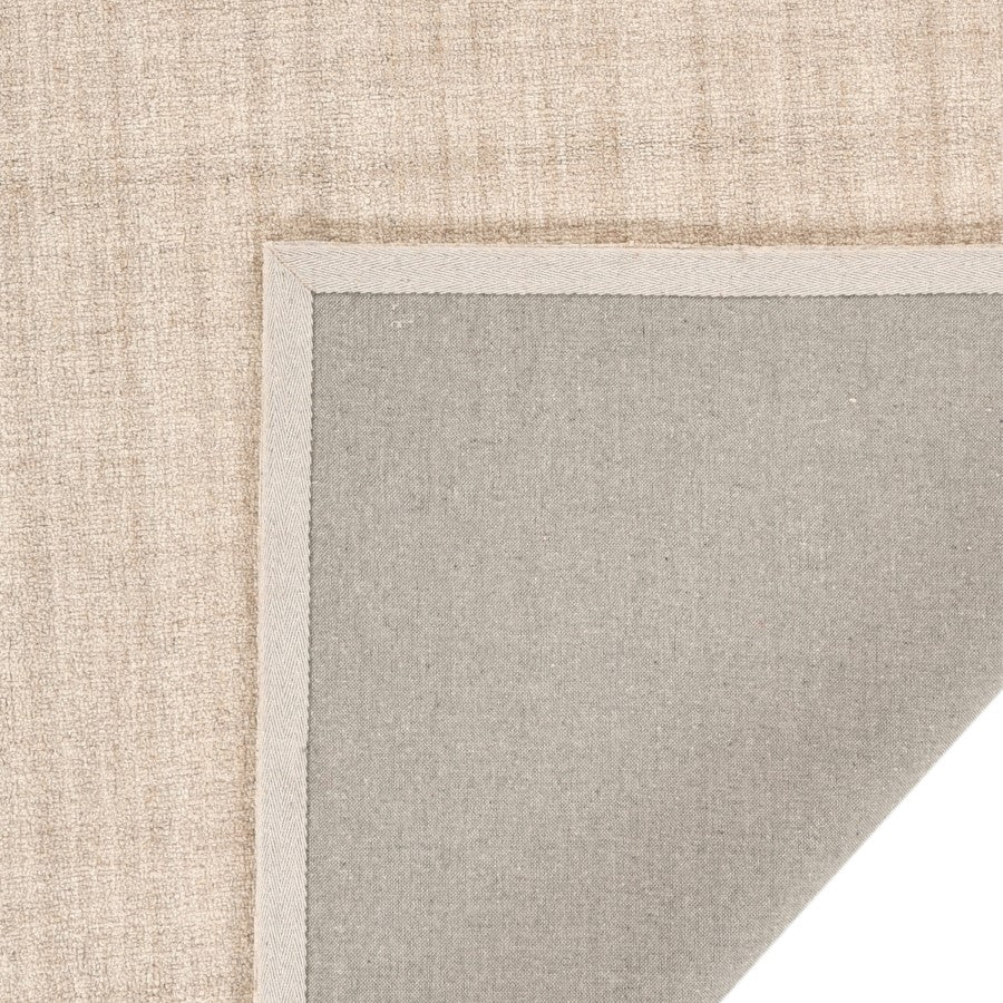 Close-up of a textured beige and gray rug corner