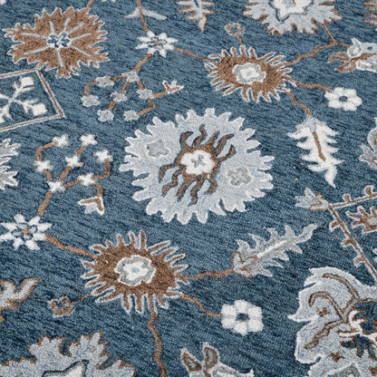 Close-up of a floral patterned rug with blue, brown, and white colors.