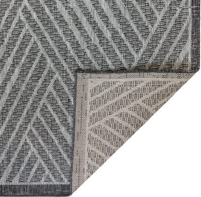 Close-up of a textured gray and white rug corner