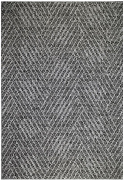 Gray and white geometric patterned rug on a plain background