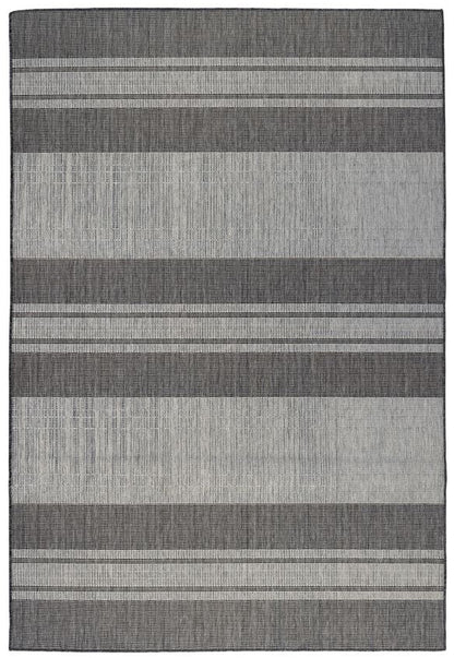 Striped gray and black rug on a white background