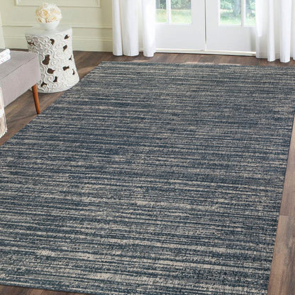 Blue striped rug in a living room setting with a couch and side table.