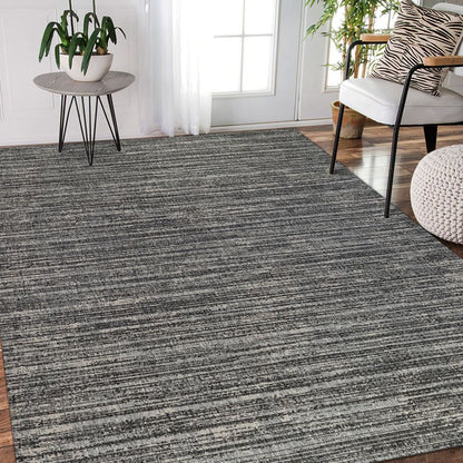 Living room with a gray striped rug, white chair, and side table.