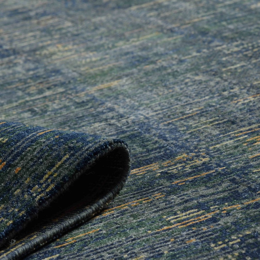 Close-up of a textured blue and green carpet roll