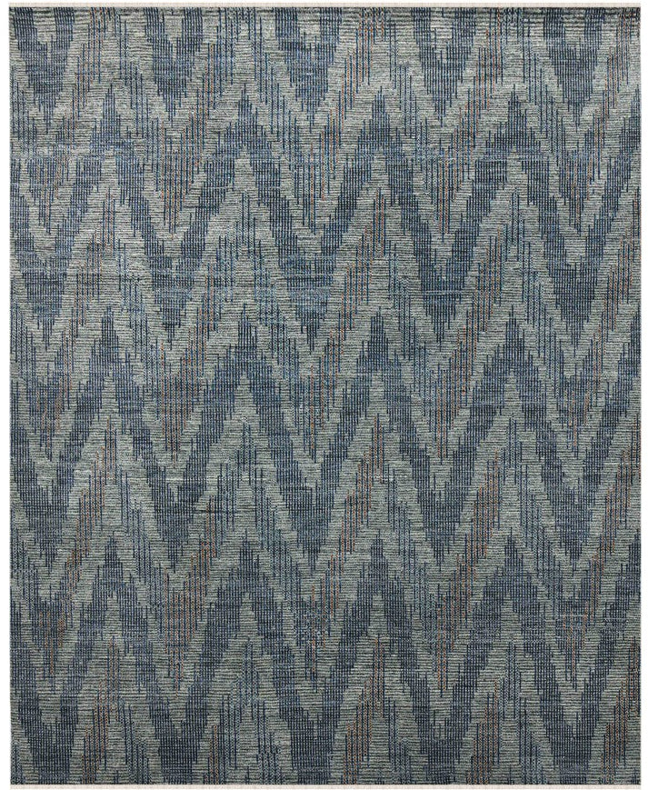 Textured area rug with a geometric pattern in shades of blue and gray.
