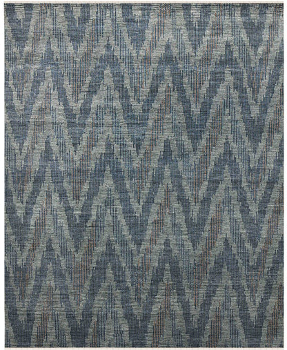 Textured area rug with a geometric pattern in shades of blue and gray.