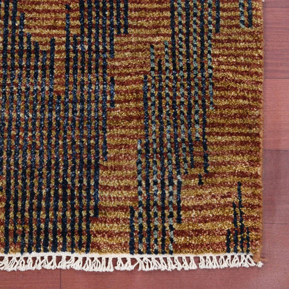 Textured brown and black patterned rug with white fringe on a red background