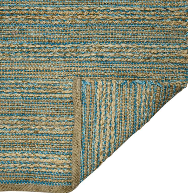 Close-up of a textured blue and beige rug corner on a white background