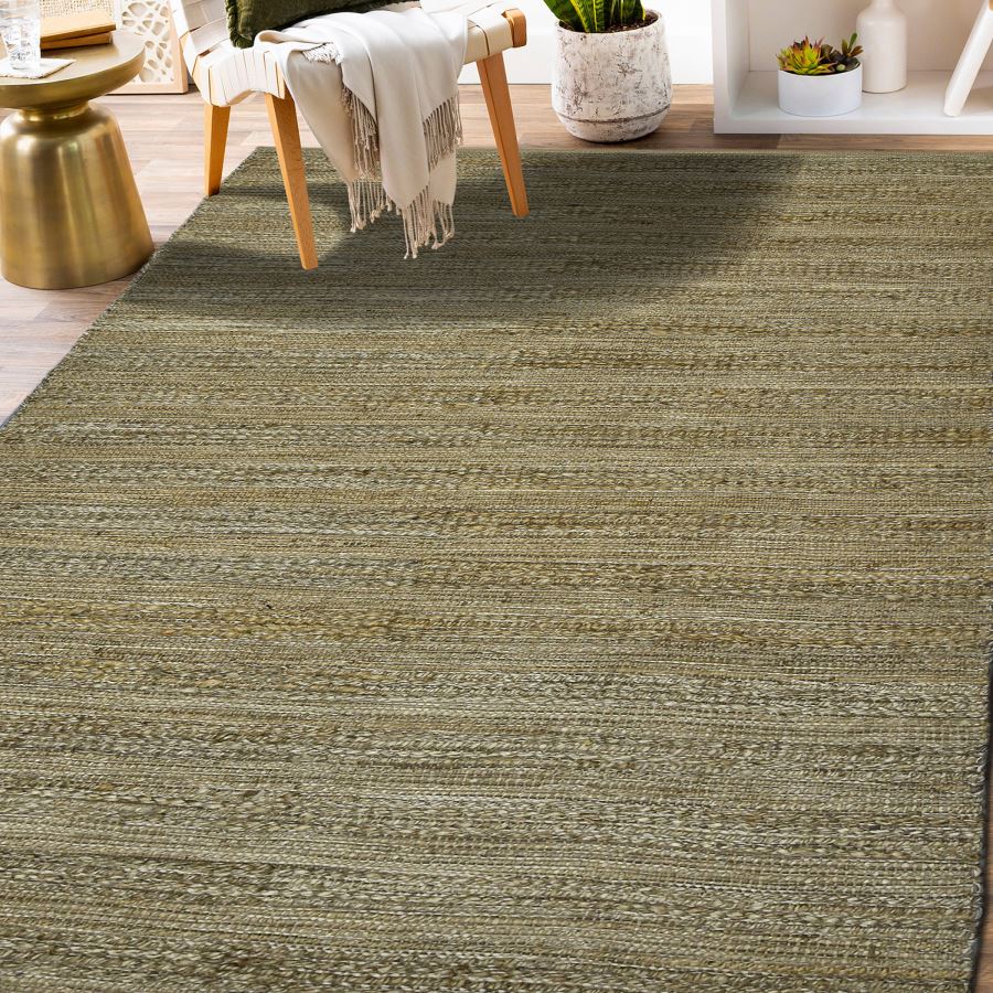 Green striped rug in a room with a chair and small table.