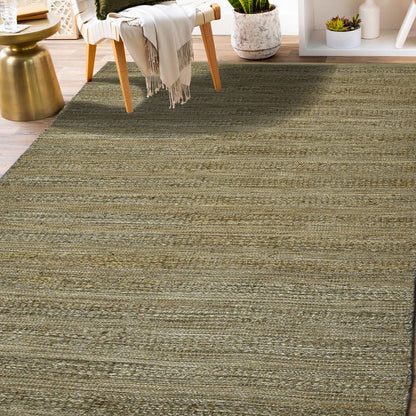 Green striped rug in a room with a chair and small table.