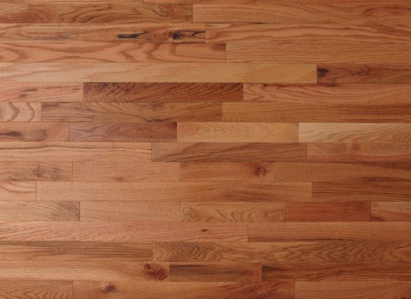 Wooden floor with planks of varying shades of brown.