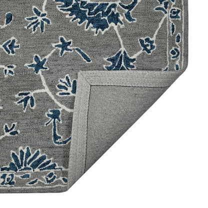 Gray rug with blue floral patterns on a white background